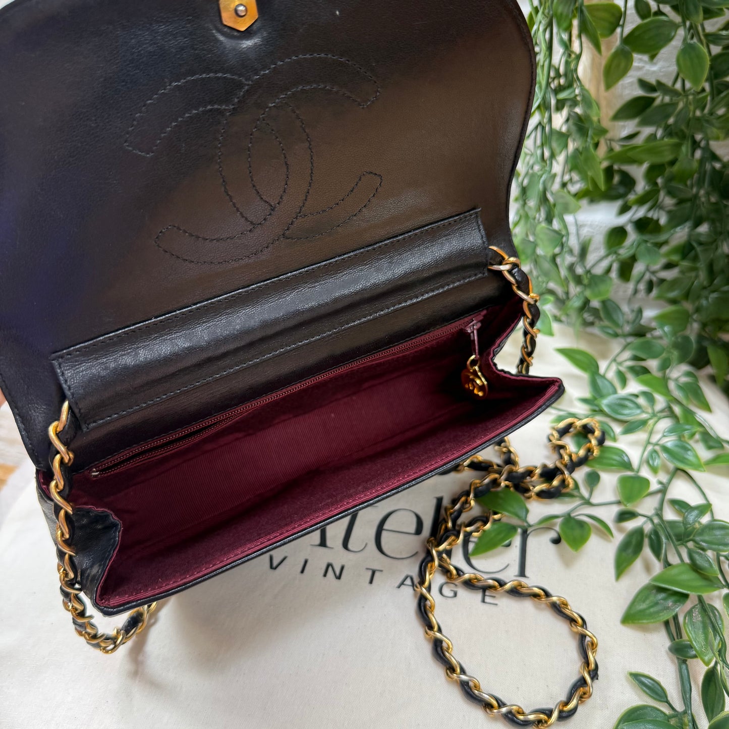 Chanel Early 1980s black half moon quilted CC button flap