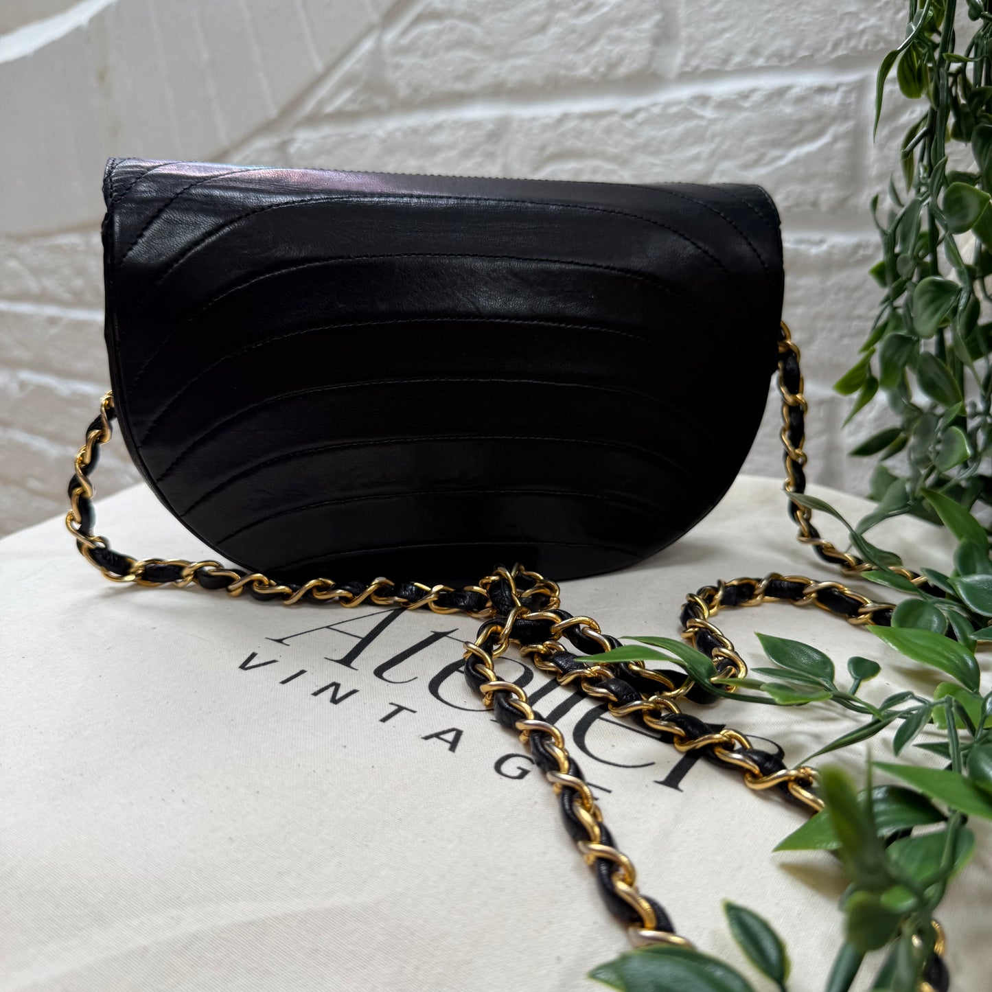 Chanel Early 1980s black half moon quilted CC button flap