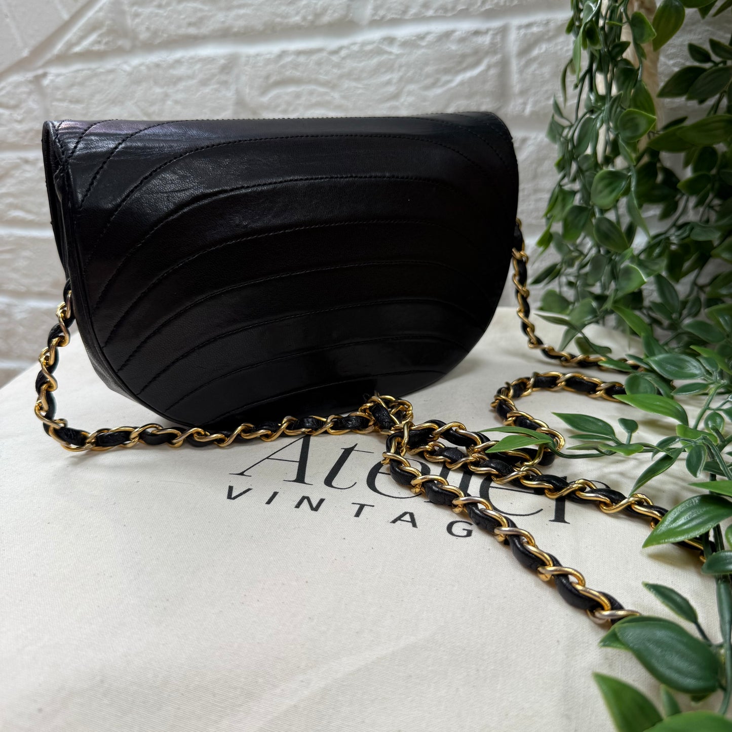Chanel Early 1980s black half moon quilted CC button flap