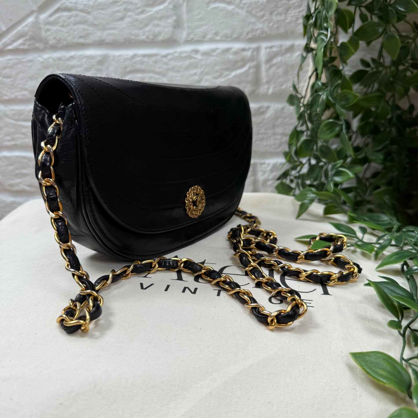 Chanel Early 1980s black half moon quilted CC button flap