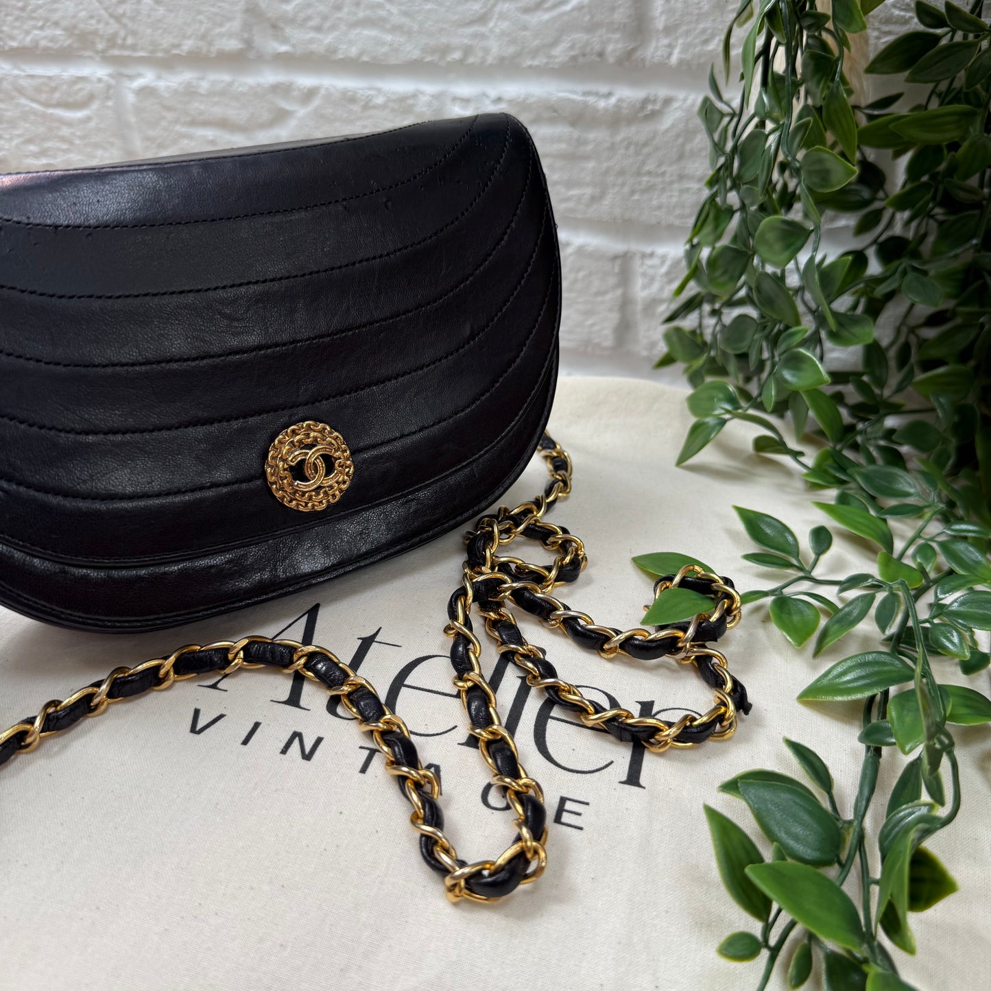 Chanel Early 1980s black half moon quilted CC button flap