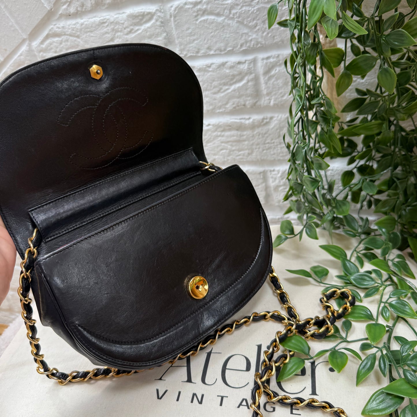 Chanel Early 1980s black half moon quilted CC button flap