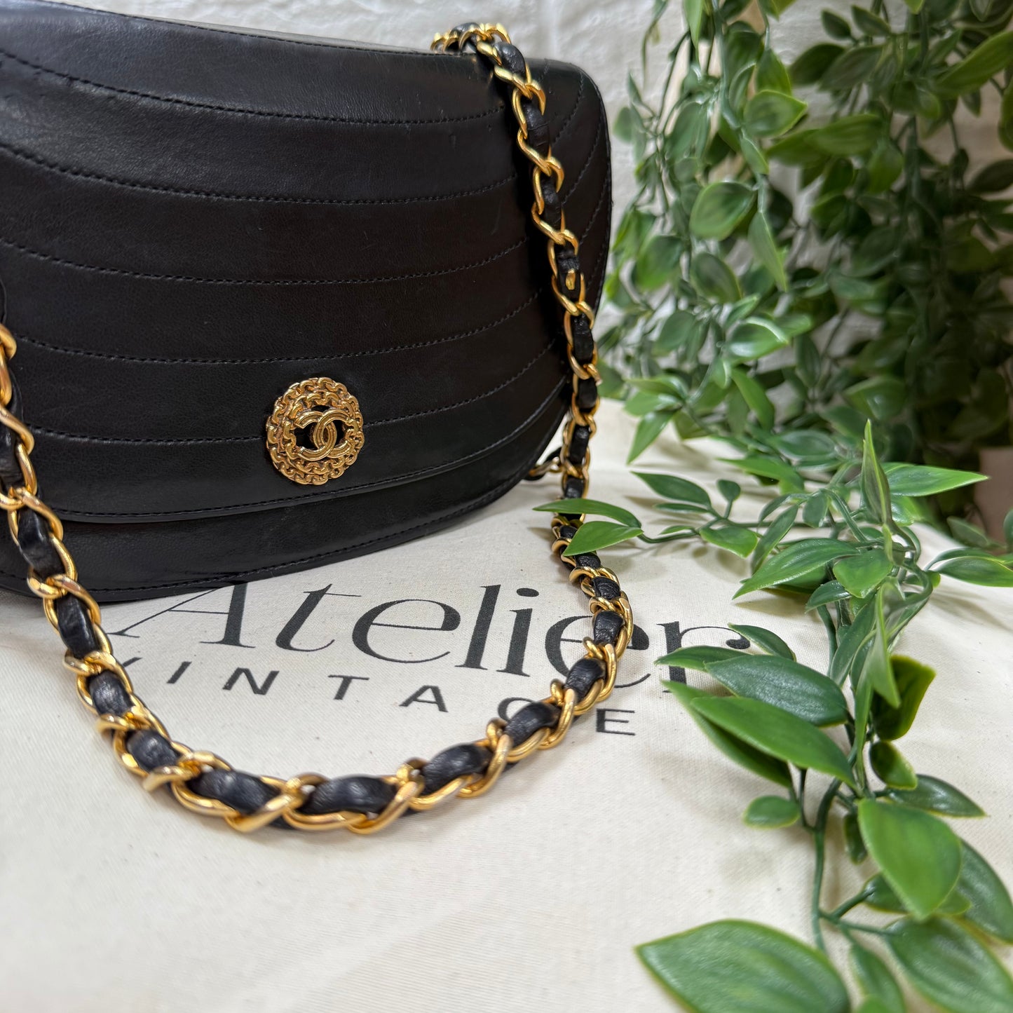 Chanel Early 1980s black half moon quilted CC button flap