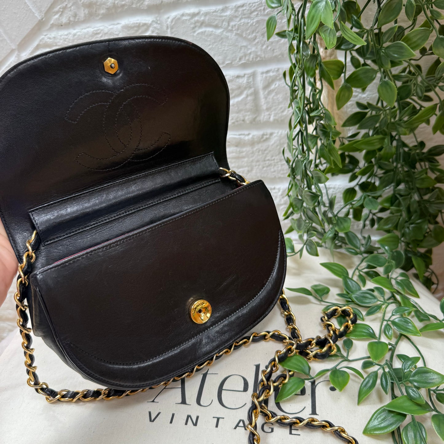 Chanel Early 1980s black half moon quilted CC button flap