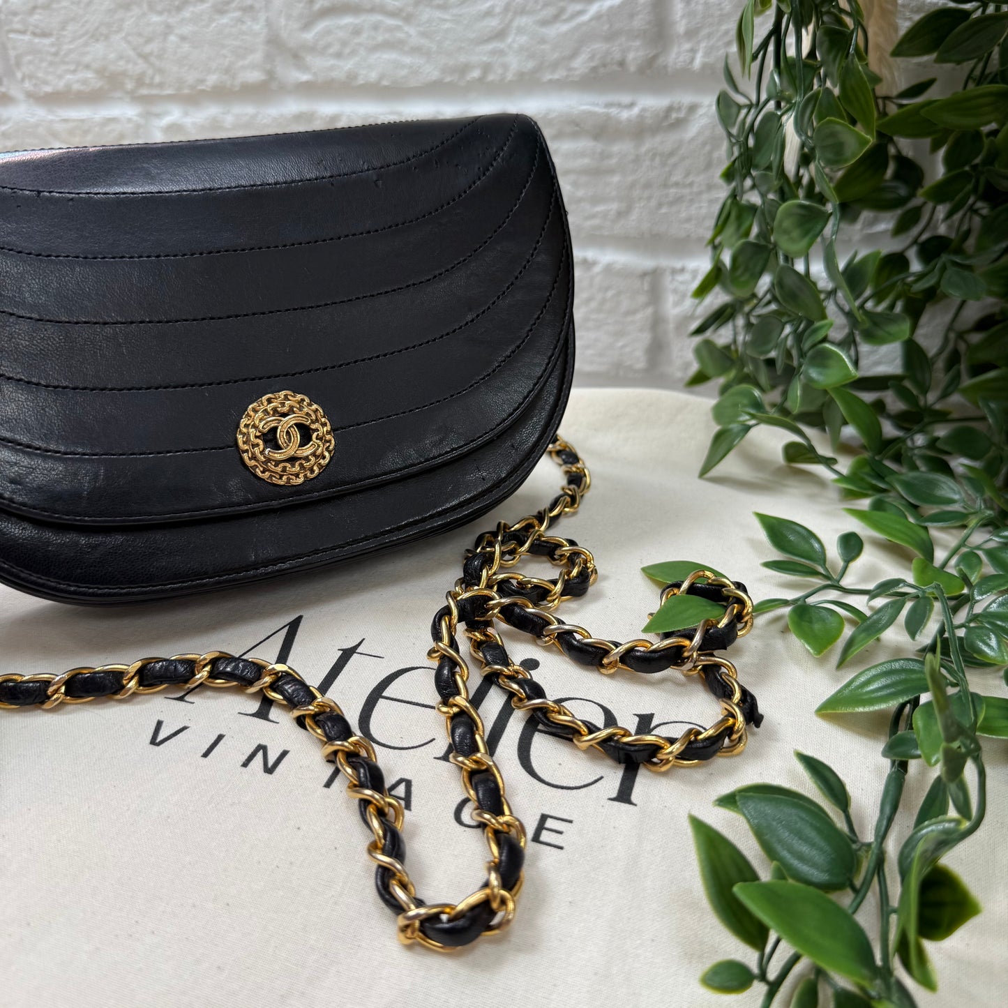 Chanel Early 1980s black half moon quilted CC button flap