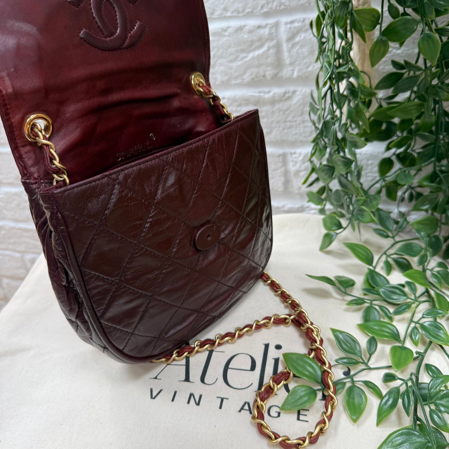 Chanel Early 1980s Bordeaux CC button half moon flap