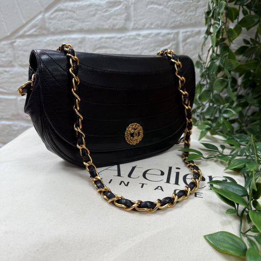 Chanel Early 1980s black half moon quilted CC button flap
