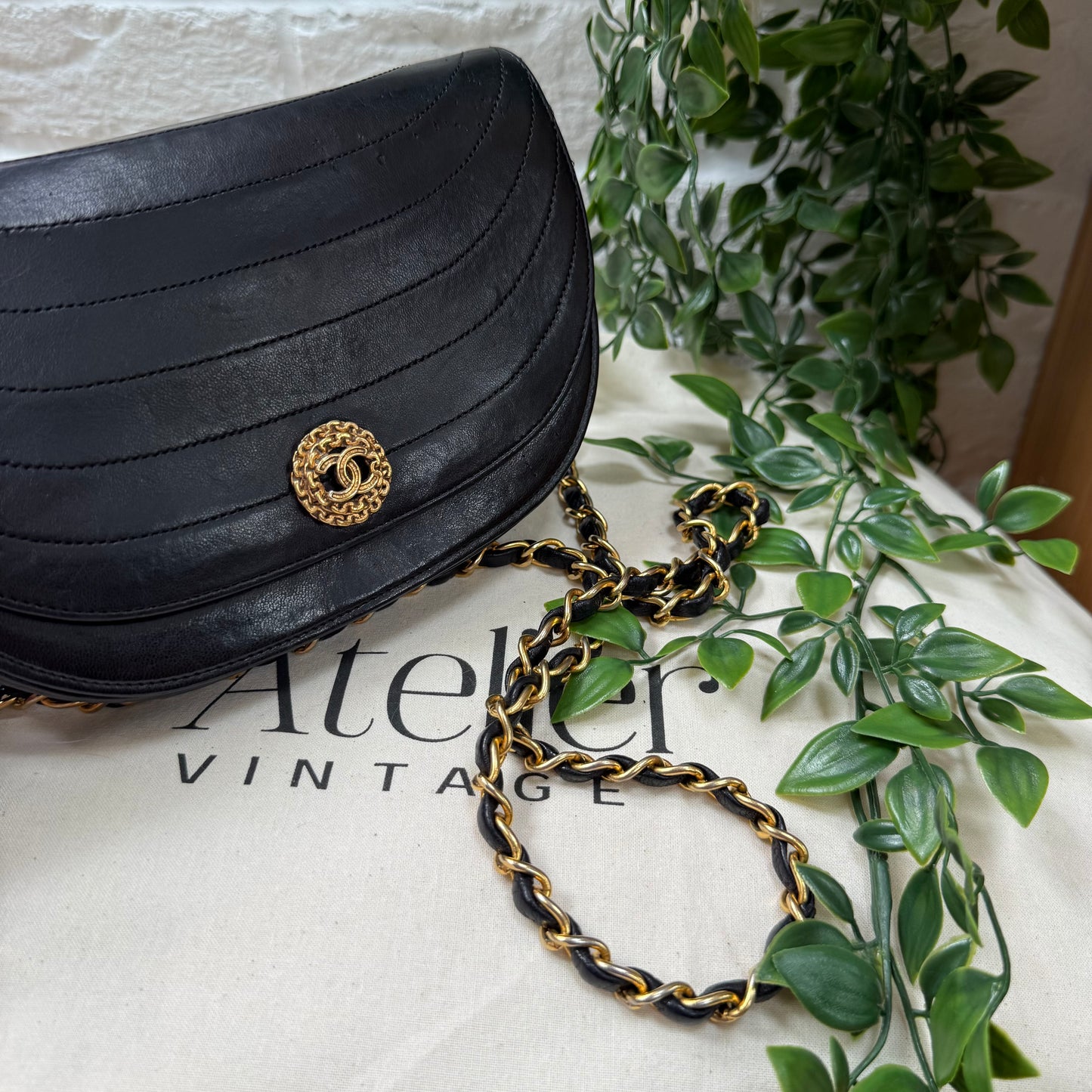 Chanel Early 1980s black half moon quilted CC button flap